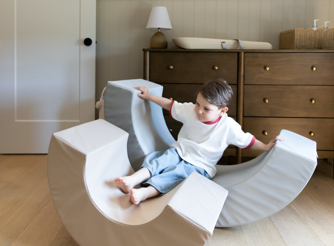 Child developing balance and core strength on North&Nova curved rocker toy